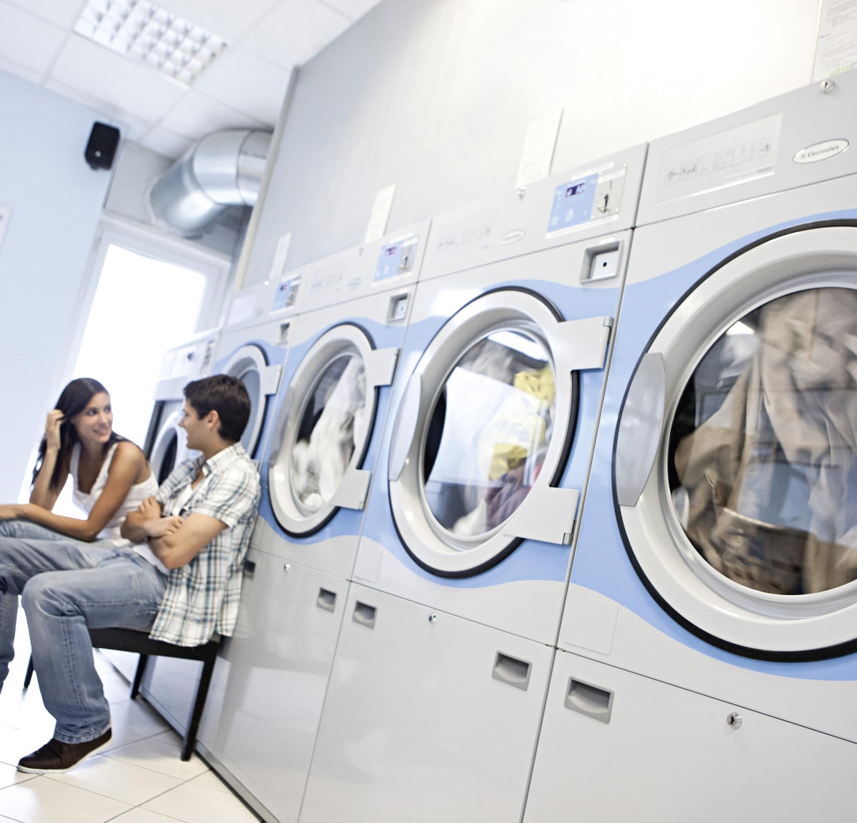 people waiting at laundromat